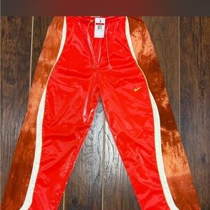 Nike Red Track Pants with White Piping and Yellow Swoosh